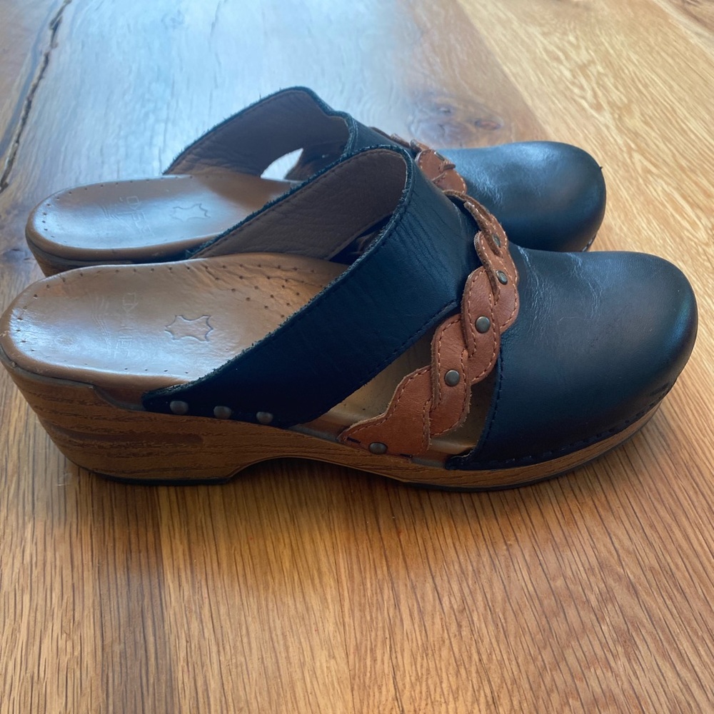 Black and Tan leather Dansko clogs.